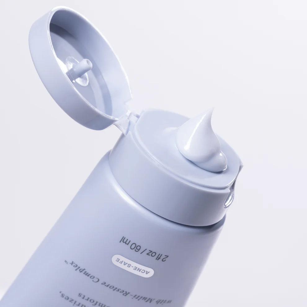 Skincare bottle with pump on a light purple background