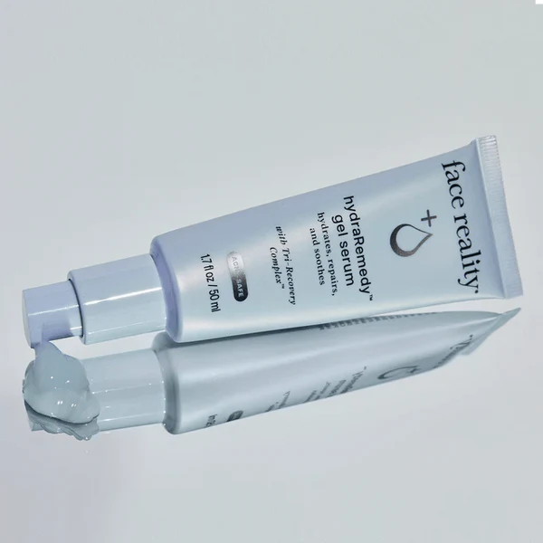 Tube of 'face reality' gel/serum on a light gray background