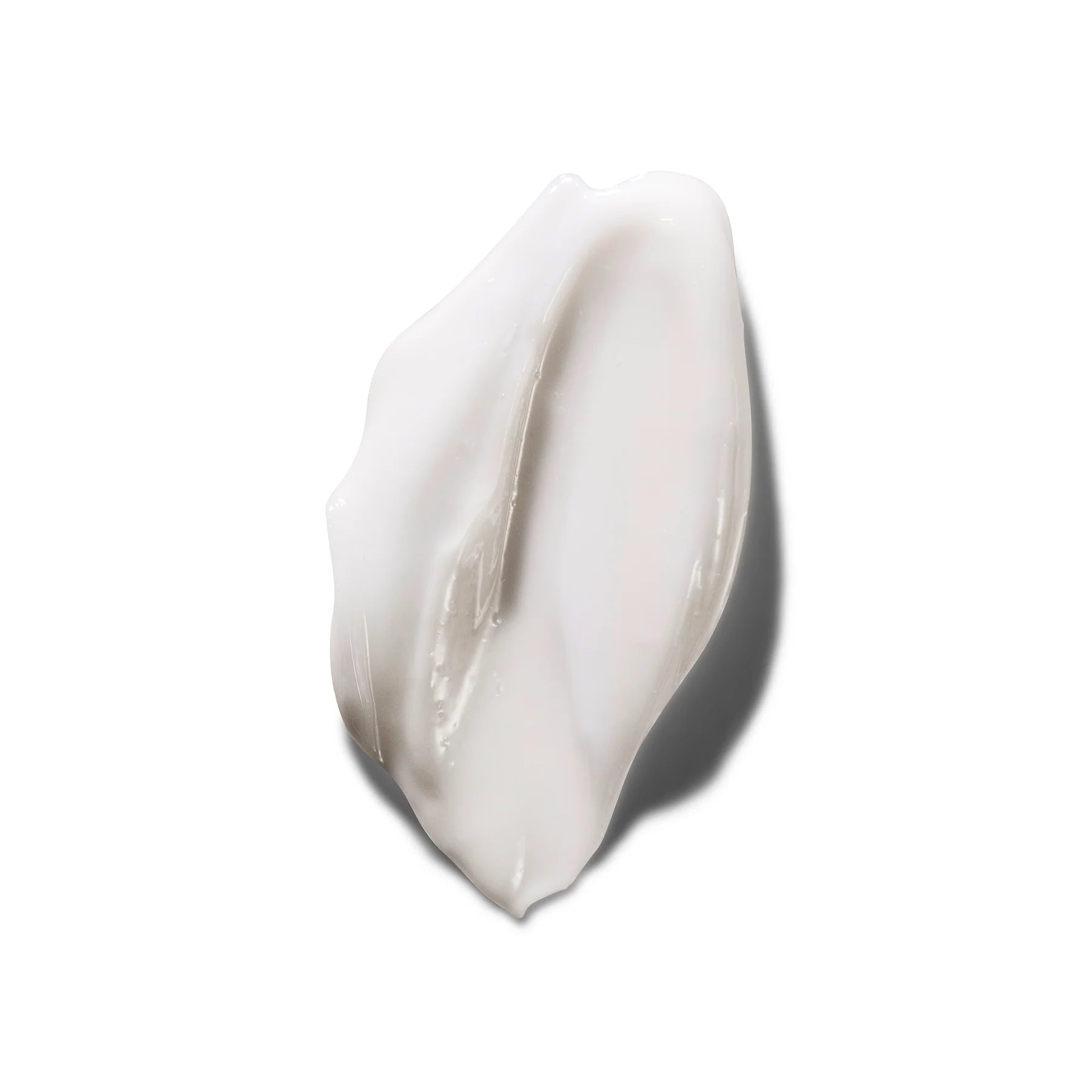 White cream smear on a light gray background