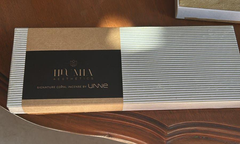 Incense packaging with 'UNNE' branding on a wooden surface