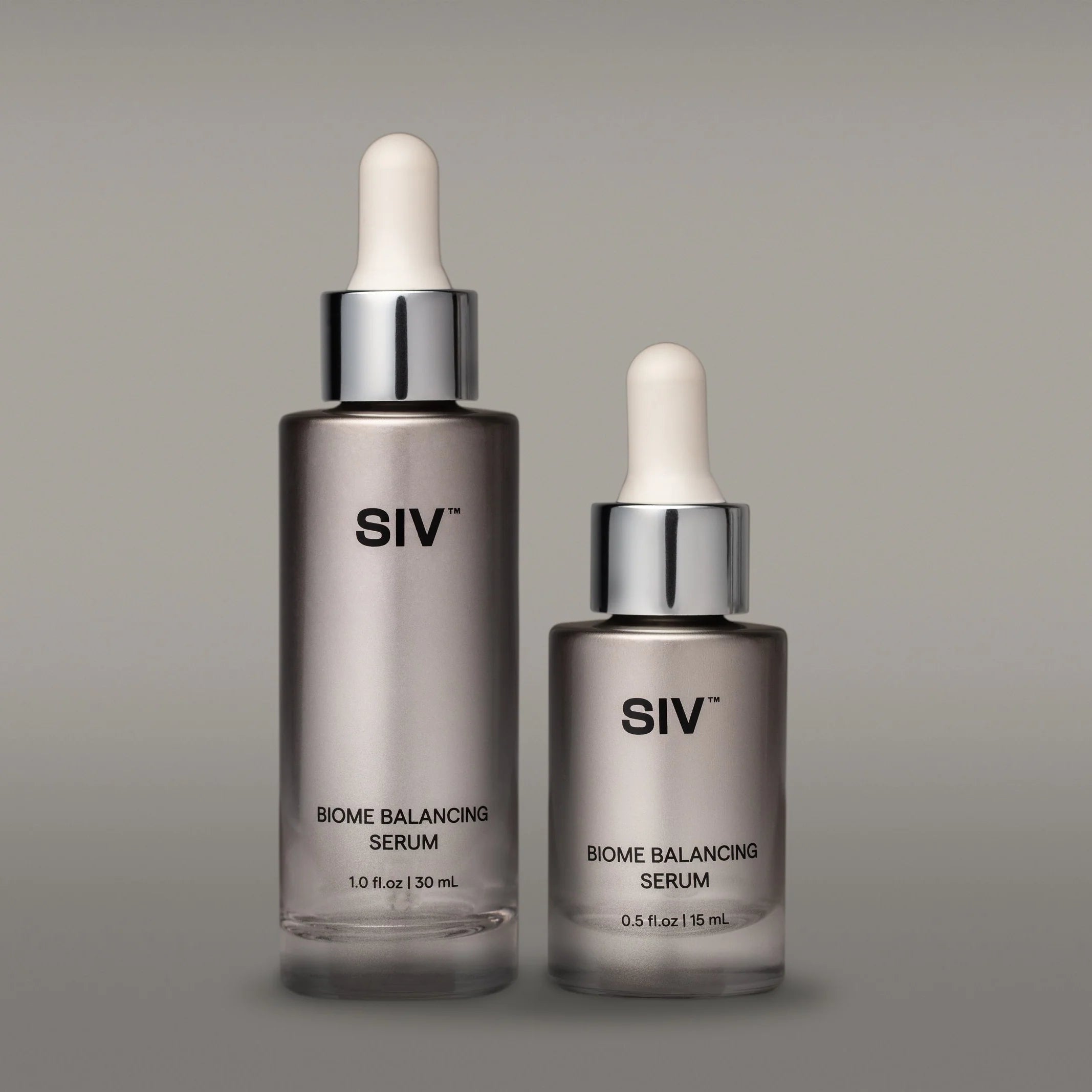 Two SIV Biome Balancing Serum bottles on a gray background