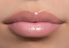 Close-up of glossy pink lips with a neutral background