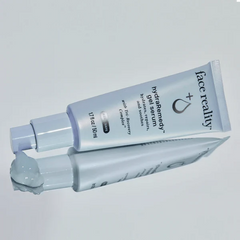 Tube of 'face reality' gel/serum on a light gray background