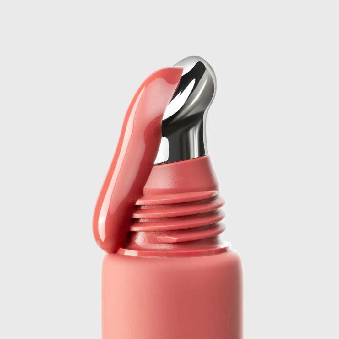 Close-up of a pink bottle cap on a light gray background