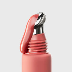 Close-up of a pink bottle cap on a light gray background